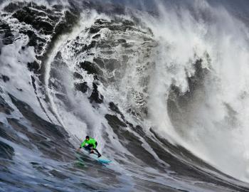 surfer riding huge wave