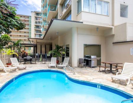 Pool chairs around the communal pool at Aqua Aloha Surf