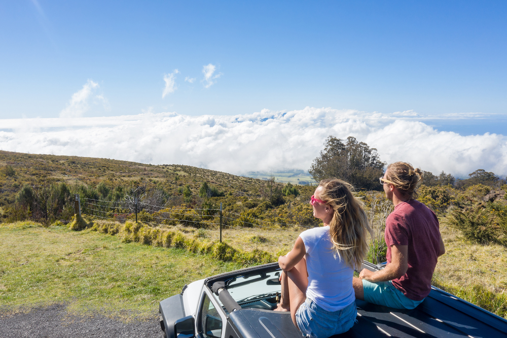 couple sitting on hood of car