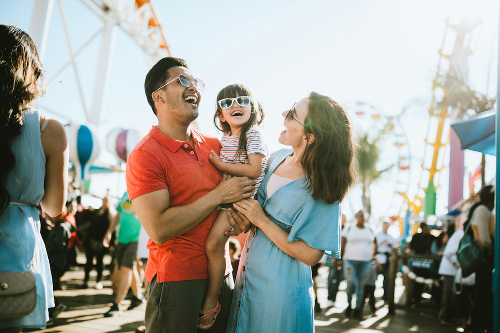 family smiling at a fair