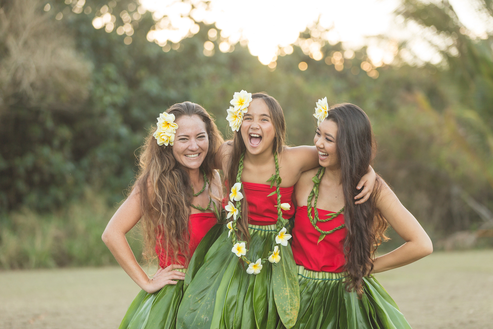 three girls of various ages in hula attire 