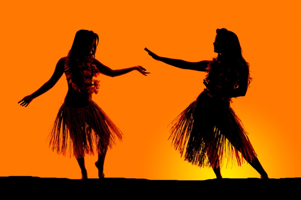 silhouette of Hawaiian woman grass skirts dancing